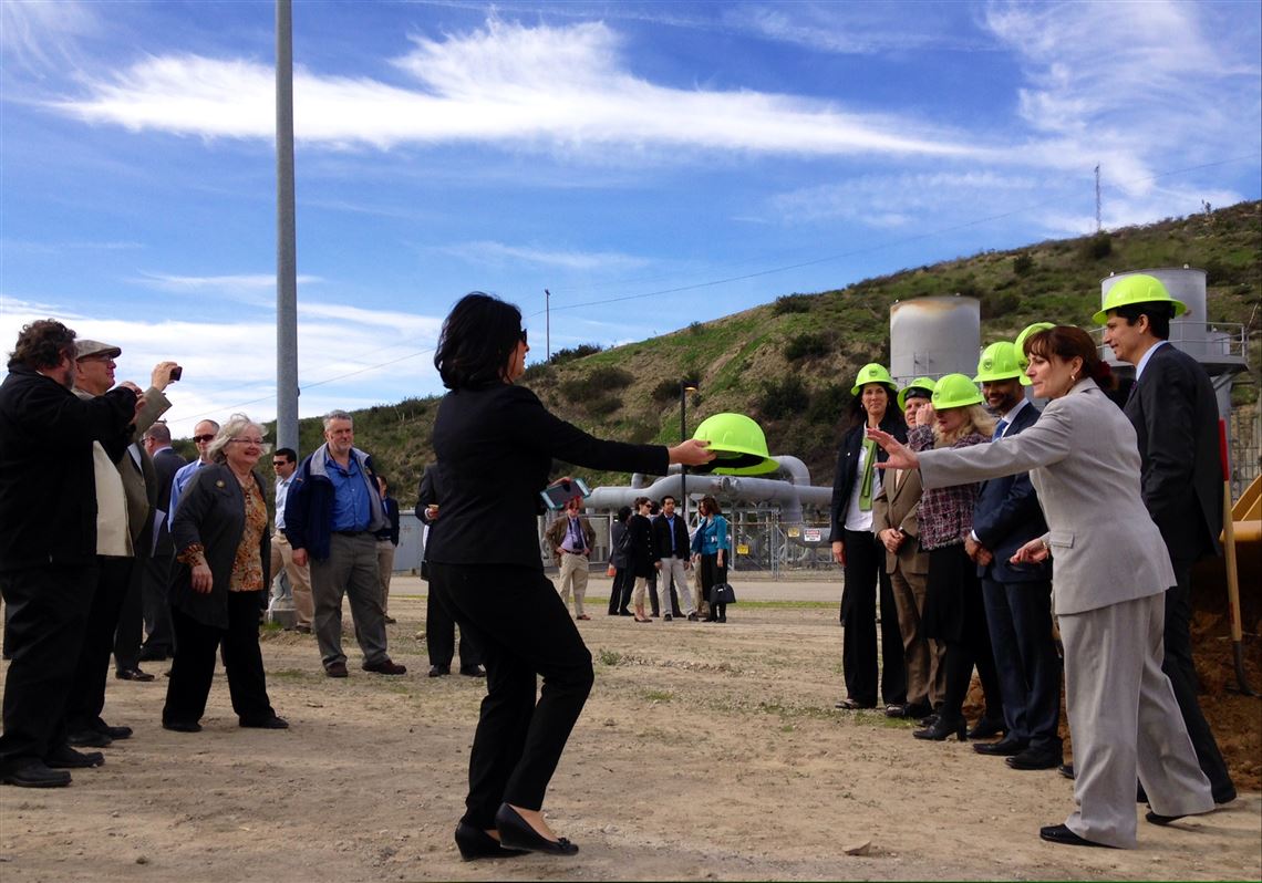 Officials attend the ground breaking ceremony the F R Bowerman Landfill, owned and operated by the Orange County Waste and Recycling, a landfill gas-to-electric power generation project at a massive Orange County landfill in Santa Ana, Calif., Thursday, Jan. 22, 2015. The $60 million plant is expected to generate 20 megawatts of electricity when it opens in a year, enough to power 14,500 homes, and will be about four or five times bigger than most garbage-to-power projects. Bowerman Power, which is owned by Montauk, will pay the county a royalty for the right to convert the landfill's methane and has a contract to sell the electricity to Anaheim Public Utilities. The financing does not include any tax breaks, subsidies or other incentives. (AP Photo/Gillian Flaccus)