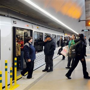 Commuters depart a train bound for the North Shore at the Gateway station. Rides between the North Shore and Downtown have been free, mostly underwritten by the Steelers.