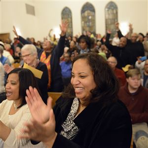 The Rev. Jacqueline Lyde of Shadyside and others cheer during a community meeting with Pittsburgh police Chief Cameron McLay at Baptist Temple Church in Homewood. 