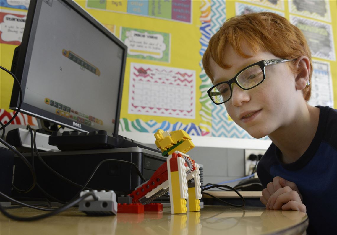 Kyle Varga, a fifth grader at Colfax Upper Elementary School, watches his "Lego Lion" robot responding to his program to sit up.