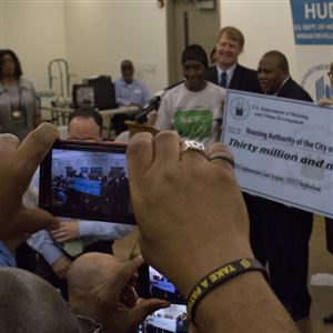 Community members take pictures in June with the $30 million Choice Neighborhood Initiative check for housing developments in the Larimer and East Liberty neighborhoods.