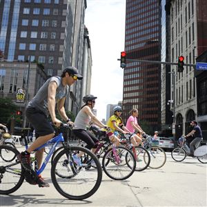 Bicyclists cross Liberty Avenue, Downtown as part of the Open Streets Pittsburgh event Sunday. 