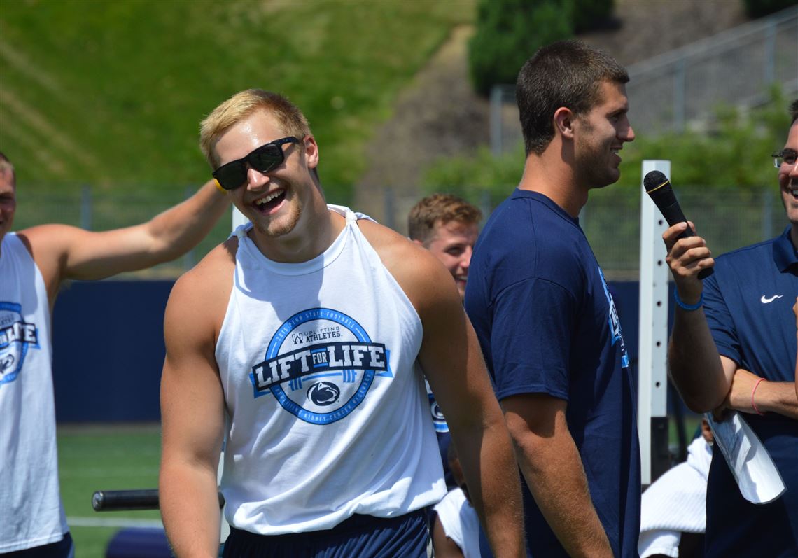 Tight end Mike Gesicki smiles after standing behind former teammate and Steelers rookie tight end Jesse James while James was interviewed in front of the crowd. 