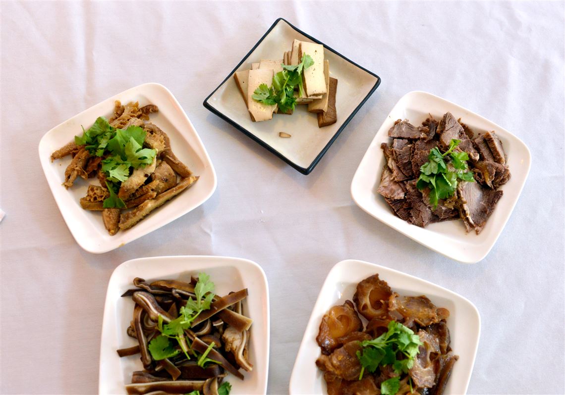 Items for breakfast at Sakura in Squirrel Hill: From top clockwise, spiced dried bean curd, beef in brown sauce, beef tendon in brown sauce, marinated pig ears and beef tripe in brown sauce.