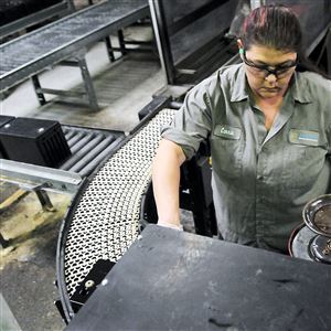 Axion Power International employee Carrie Colick sprays and dries battery components in a process called finishing.