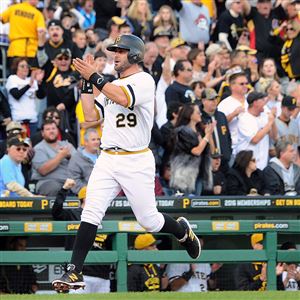 Francisco Cervelli cheers with the crowd as he heads home to put the Pirates up 3-0 against the Cincinnati Reds at PNC Park.