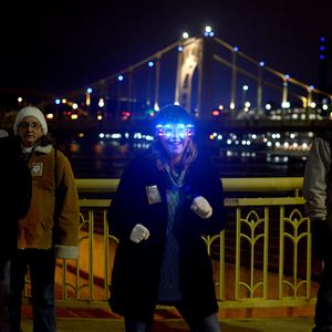Sherri Ellison of Sarver dances on the 7th Street Bridge while waiting for the evening's first fireworks show to begin during First Night Pittsburgh, the annual New Year's Eve celebration, in Downtown Pittsburgh tonight.  