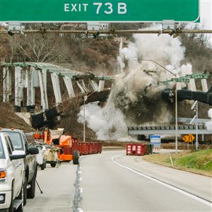 The Greenfield Bridge is demolished in a controlled explosion over the Parkway East on Monday morning.