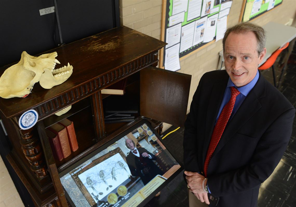 John Pollock, a Duquesne University biologist, stands next to his Darwin Synthetic Interview, a multimedia experience that will be available for the Darwin Day celebration Thursday.