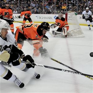The Penguins' Carl Hagelin and the Flyers' Brandon Manning fight for the puck during a game April 3 at Consol Energy Center.  