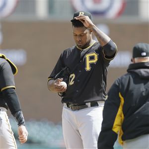 Pirates pitching coach Ray Searage, right, and catcher Francisco Cervelli, left, walk to the mound for a conversation with pitcher Juan Nicasio during the third inning.