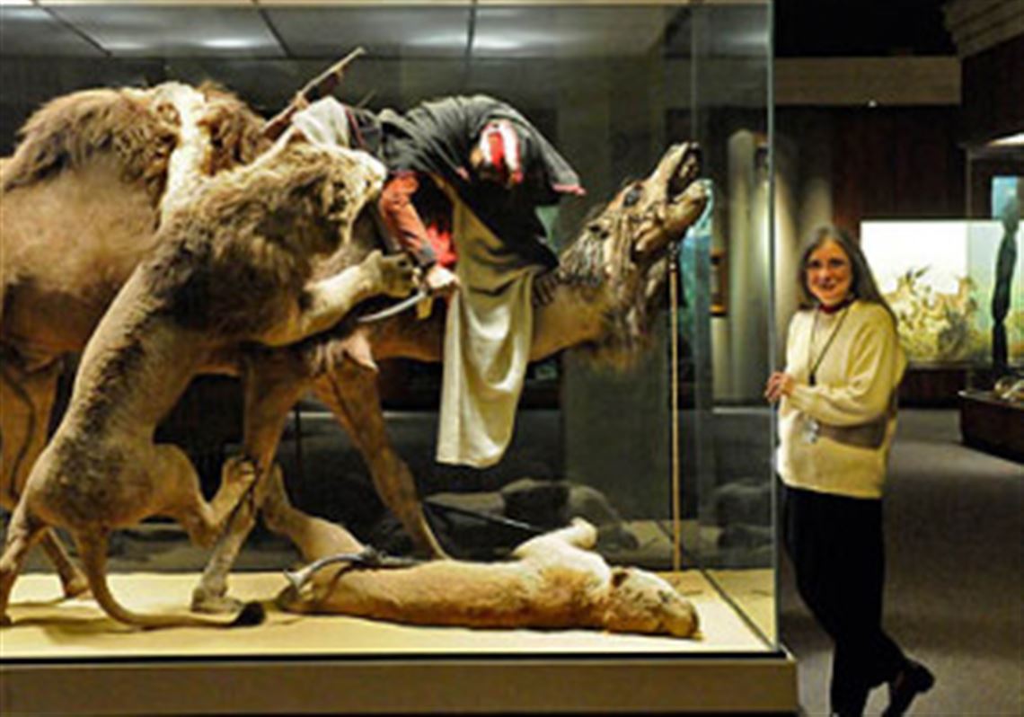 Suzanne McLaren of the Carnegie Museum of Natural History with the venerable "Arab Courier Attacked by Lions" exhibit in 2009.