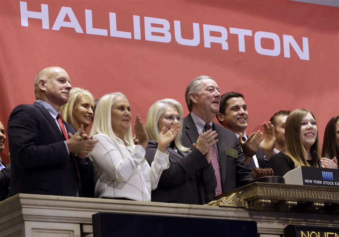FILE - In this Nov. 17, 2014, file photo, traders gather at the post that handles Baker Hughes on the floor of the New York Stock Exchange. Two companies crucial to the business of U.S. energy exploration — Haliburton and Baker Hughes — have abandoned their planned merger. The Justice Department disclosed the plans on Sunday, May 1, 2016. (AP Photo/Richard Drew, File)