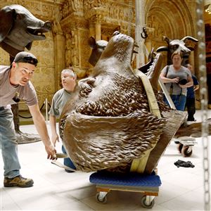 Frank Messina, left and Michael McAveney, second from left, crewman from More Specialized Transport of New Jersey, assist Wednesday in erecting 12 bronze figures of the Chinese Zodiac at the Carnegie Museum of Art’s Hall of Architecture in Oakland.