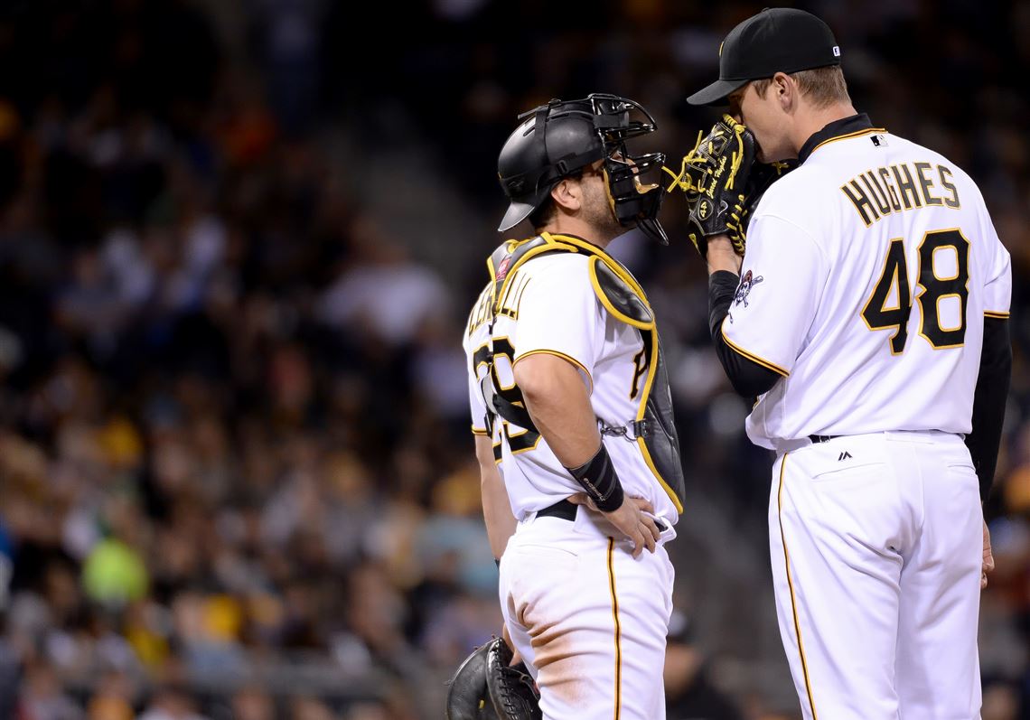The Pirates' Francisco Cervelli talks with pitcher Jared Hughes in the eighth inning against the Mets Wednesday at PNC Park.