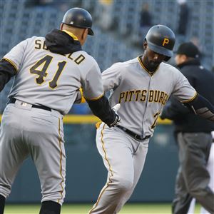 Third-base coach Rick Sofield congratulates Andrew McCutchen as he circles the bases in the first inning April 26 in Denver, Colo. McCutchen hit three home runs that game.