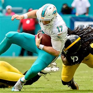 Dolphins quarterback Ryan Tannehill is tackled by linebacker Jarvis Jones Sunday at  Hard Rock Stadium in Miami Gardens, Fla.