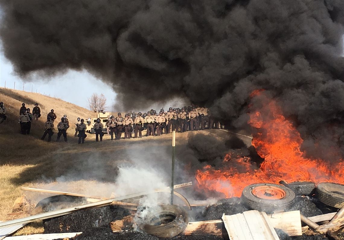 Dakota Access pipeline protesters confront law enforcement on Thursday, Oct. 27, 2016, near Cannon Ball, N.D. The months-long dispute over the four-state, $3.8 billion pipeline reached a crisis point when the protesters set up camp on land owned by pipeline developer Energy Transfer Partners. The disputed area is just to the north of a more permanent and larger encampment on federally-owned land where hundreds of protesters have camped for months.   (Caroline Grueskin/The Bismarck Tribune via AP)