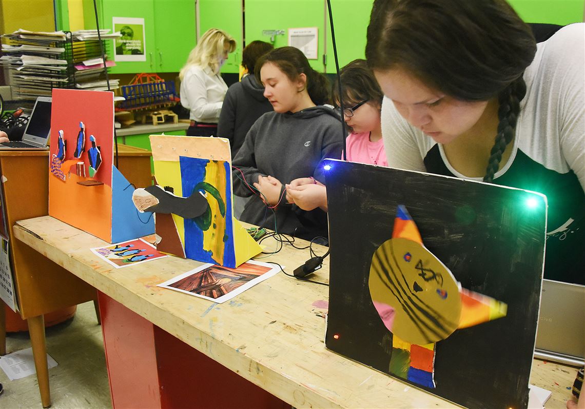 South Allegheny Middle School student Mary Humphries, right, looks up from her laptop to check on her  animated cat she named “Kittie," during Jayme Sweet’s eighth-grade art class.