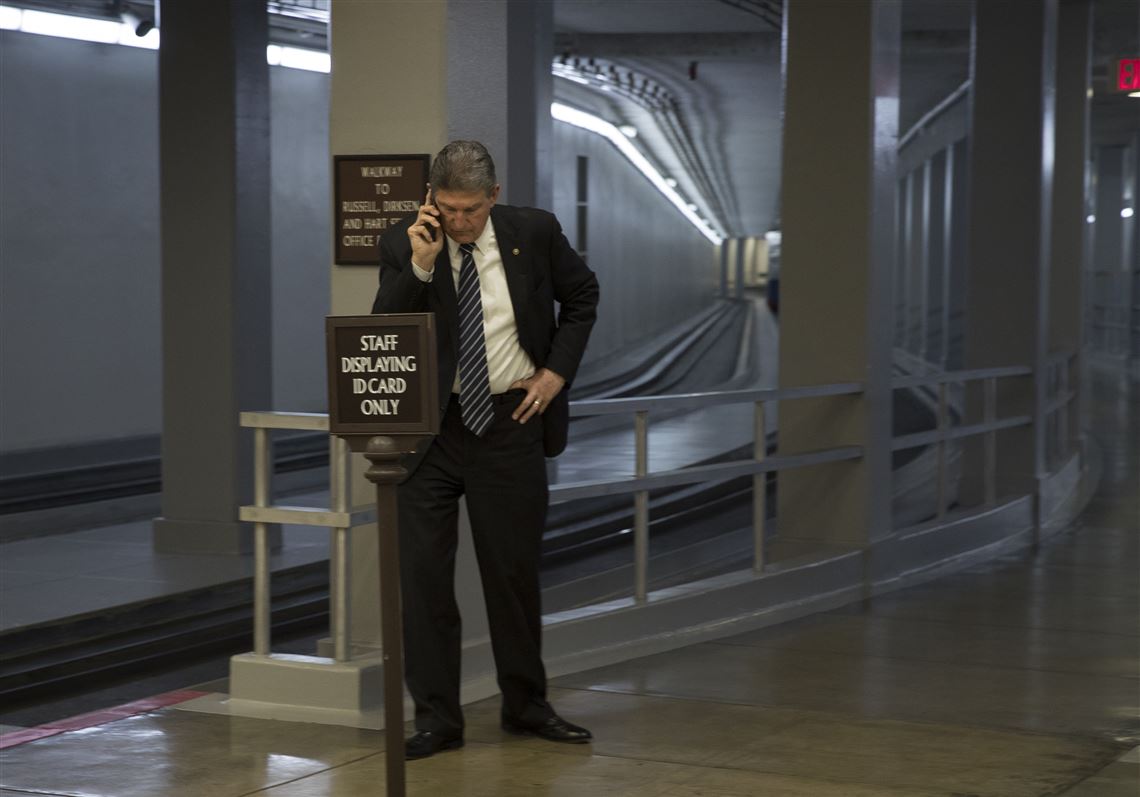 Sen. Joe Manchin (D-W.Va.) en route to the Senate floor to discuss a continuing resolution to avert a government shutdown, on Capitol Hill in Washington on Friday. An effort by Manchin to extend the Miners Protection Act will apparently result in only a temporary fix.