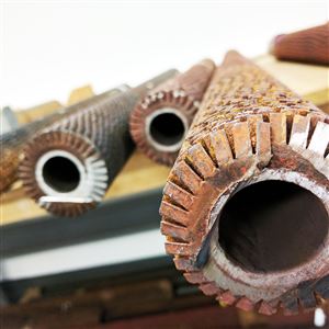 Finned tubes from a heat recovery steam generator unit are sprawled across the table at TesTex, a Monroeville-based company that has developed several techniques to inspect these hard-to-reach pipes.