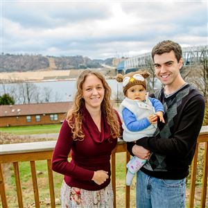 Dan and Gina Rubino with their 1-year-old daughter, Maria, on the back porch of their Vanport home. The couple's house overlooks the Ohio River and the site of Shell's planned ethane cracker plant.