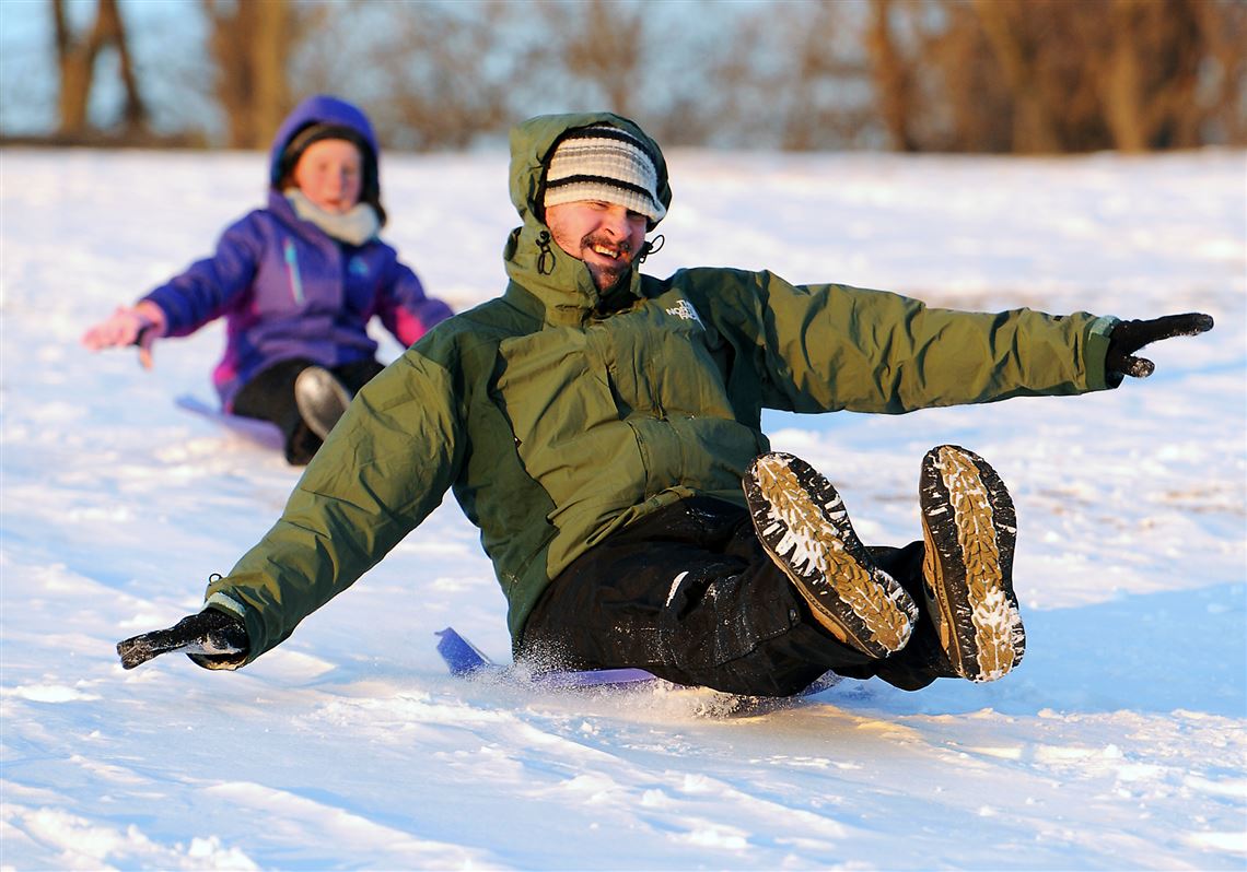 Former Pittsburgher Jon Tierney, now living in Virginia Beach, and his 9-year-old daughter, Lizzy, try the sledding on Sunny Slopes in South Park County Park.