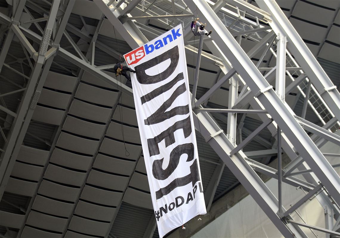 Protesters against the Dakota Access Pipeline rappel from the catwalk in U.S. Bank Stadium during the first half of an NFL football game between the Minnesota Vikings and the Chicago Bears, Sunday, Jan. 1, 2017, in Minneapolis. (AP Photo/Andy Clayton-King)