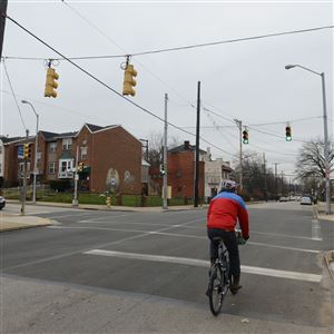 A bicyclist rides down Hamilton Avenue near the intersection of North Homewood Avenue on Sunday in Homewood. Pittsburgh's Urban Redevelopment authority has received a state grant that will allow it to make sidewalk and intersection improvements in Homewood in a rectangle bounded by Braddock and Homewood avenues, from the East Busway to Hamilton Avenue.