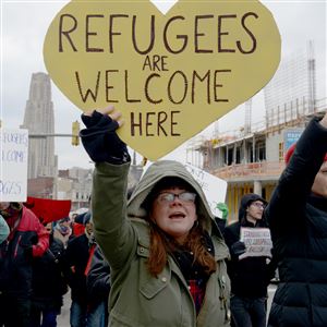 Ami Garbark of Lawrenceville marches along Forbes Avenue during a rally in solidarity with immigrants, Muslims and refugees on Saturday. 