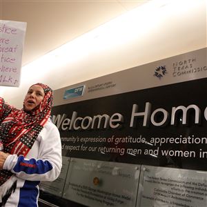 Yolanda Roa, a Latina Muslim, joins the protest at Dallas-Fort Worth International Airport on Saturday to denounce Donald Trump's executive order that bans certain immigration.