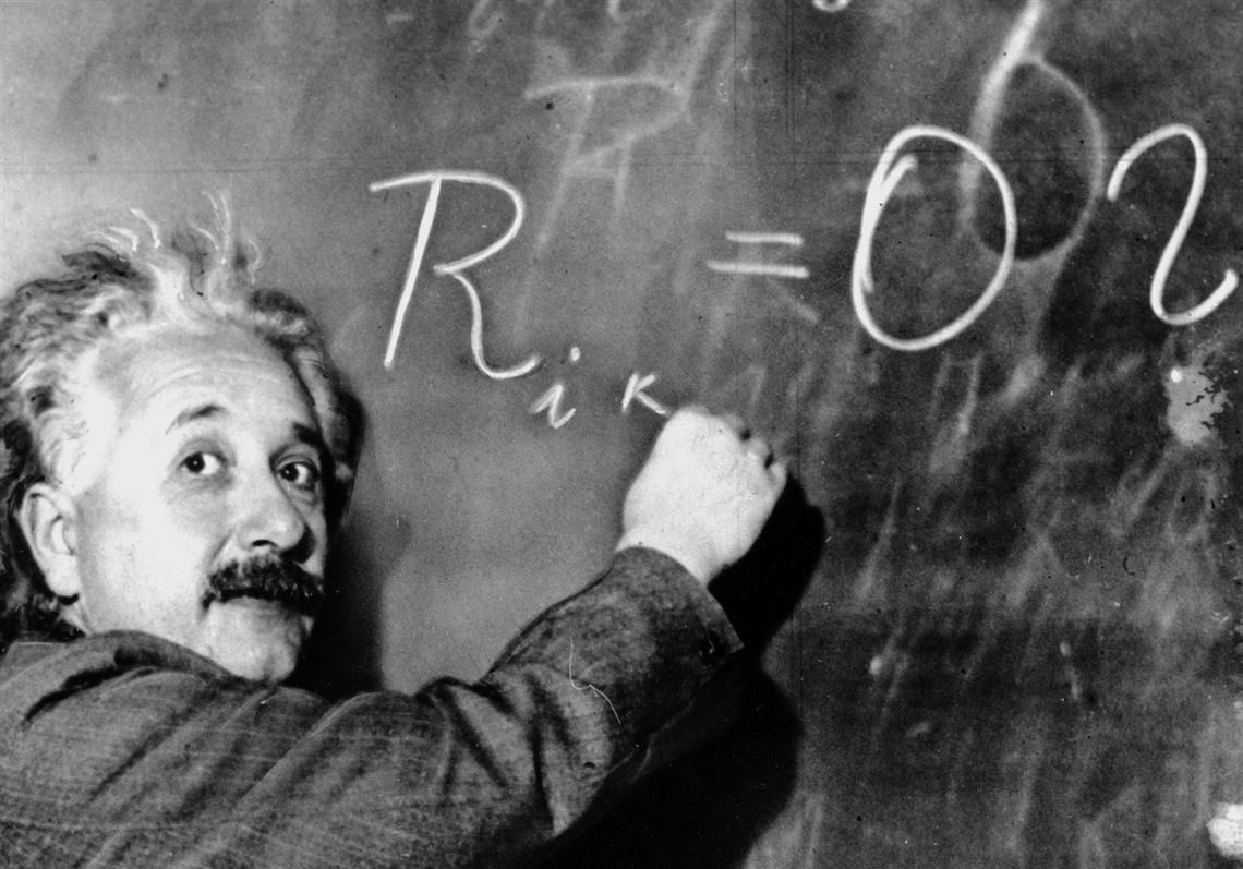 Albert Einstein writes an equation for the density of the Milky Way on the blackboard at the Carnegie Institute, Mt. Wilson Observatory headquarters in Pasadena, Calif.