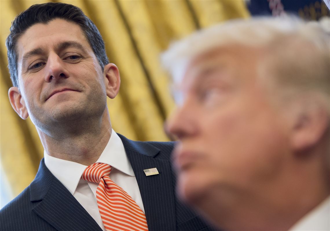 President Donald Trump speaks to House Speaker Paul Ryan, R-Wis., after signing House Joint Resolution 41, which removes some Dodd-Frank regulations on oil and gas companies, during a bill-signing ceremony in the Oval Office of the White House in Washington, D.C., on Tuesday.