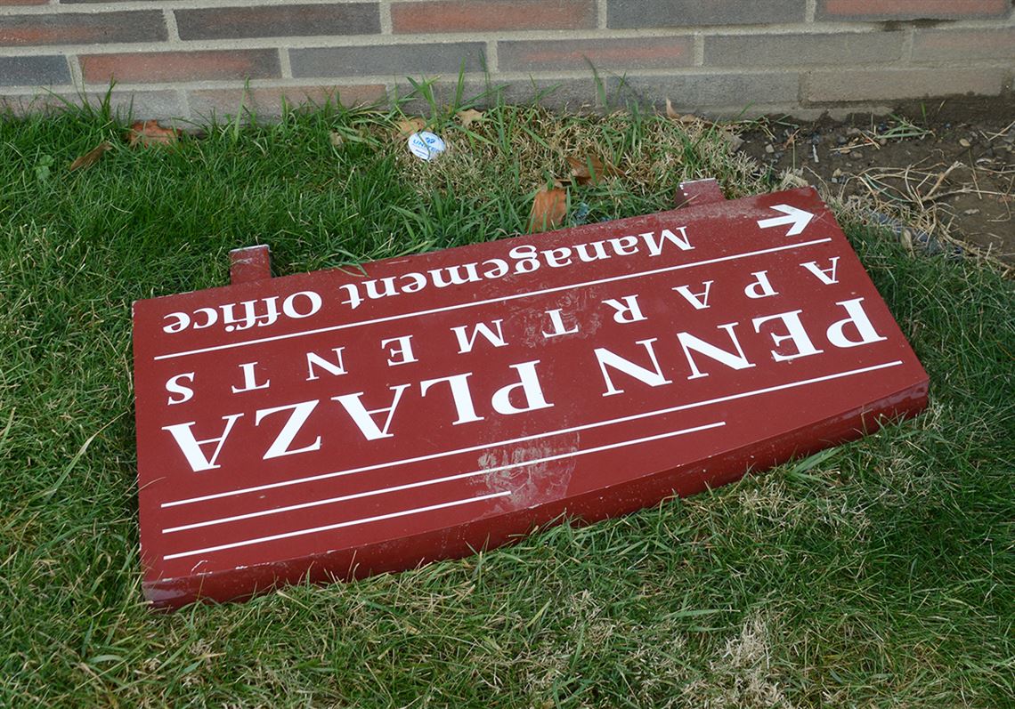 A sign for the Penn Plaza Apartments in East Liberty lays on the ground.