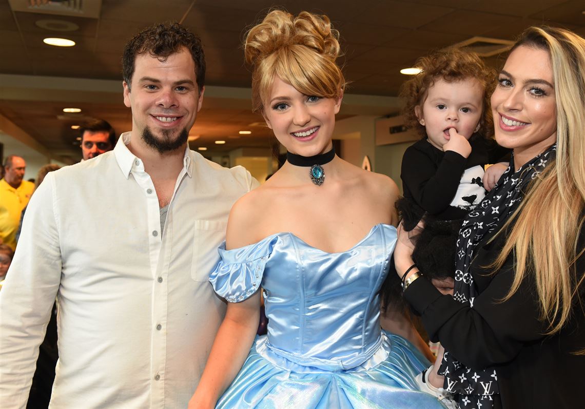 Tyler Kennedy, left, and Brandi Kennedy, far right, holding Cookie, 17 months, with Cinderella (Elena Doyno). 