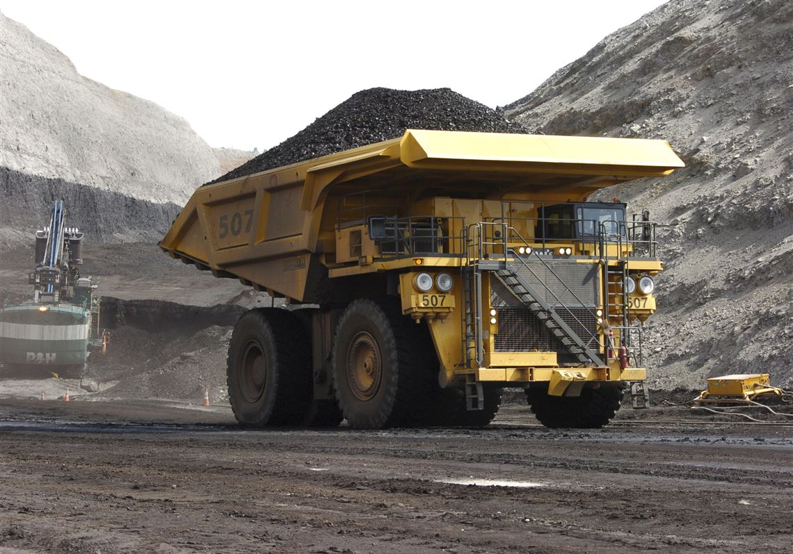 In this April 4, 2013, file photo, a mining dumper truck hauls coal at Cloud Peak Energy's Spring Creek strip mine near Decker, Mont. Renewable energy developers say they're hopeful about the future despite President-elect Donald Trump's promise to bring coal mining jobs back. In recent years, huge solar and wind farms have sprouted up on public desert land in the Western United States buoyed by generous federal tax credits.