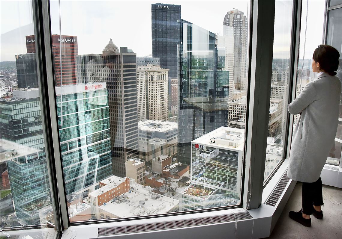 Sofia Burno, the interior designer for    "Industrious," looks at the Pittsburgh skyline from the 31st floor of One PPG Place. Industrious has office space , desks and conference rooms for "start ups".     