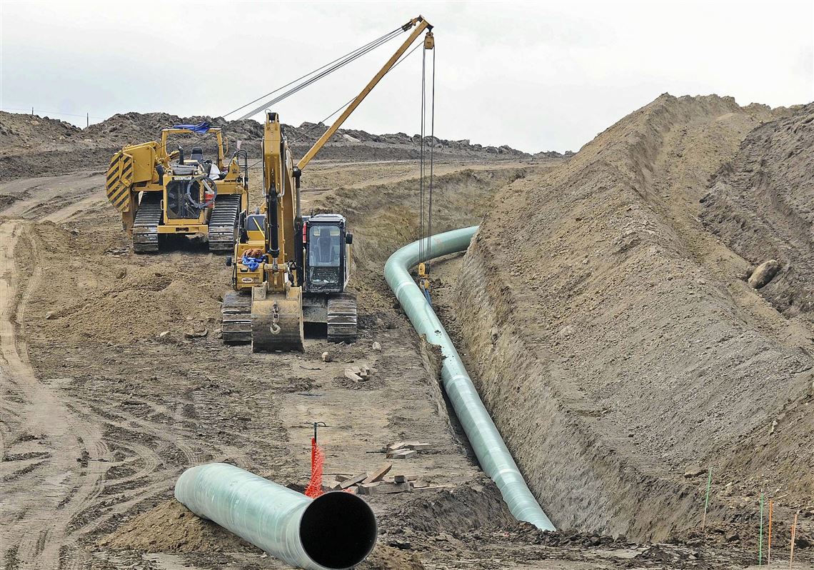 FILE - In this Oct. 5, 2016, file photo, heavy equipment is seen at a site where sections of the Dakota Access pipeline were being buried near the town of St. Anthony in Morton County, N.D. American Indian tribes who are still fighting the Dakota Access oil pipeline in court have dropped an appeal of a federal judge's decision that allowed final construction to proceed on the project that is just two weeks from operating commercially. U.S. District Judge James Boasberg in early March refused to stop completion of the pipeline based on the claims of Sioux tribes that it threatens water they consider sacred. (Tom Stromme/The Bismarck Tribune via AP, File)