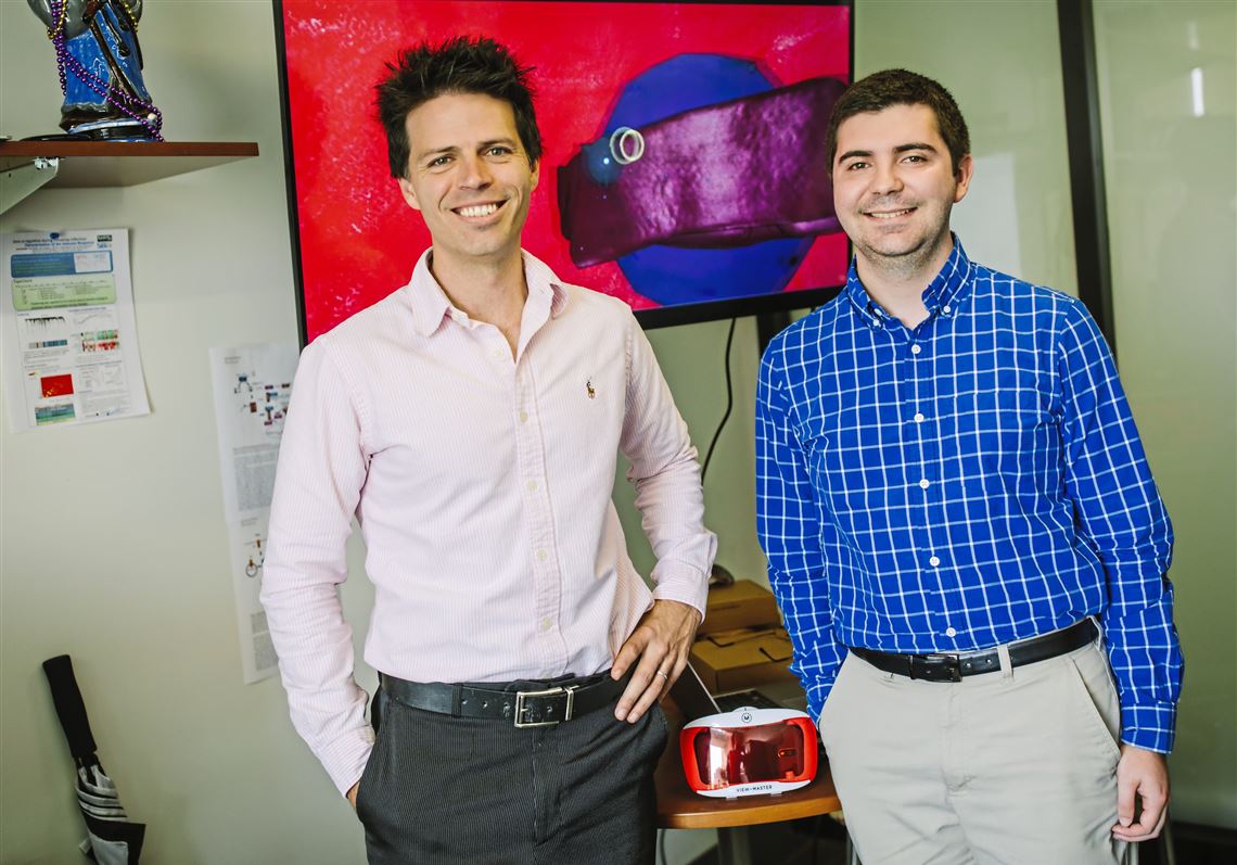University of Pittsburgh Professor Jason Shoemaker, left, and student project manager Robert Gregg pose for a portrait on campus on September 21, in Oakland. The pair lead a team that created a VR game called vir-ed that allows biology and biochemistry students to virtually travel inside a blood vessel. 