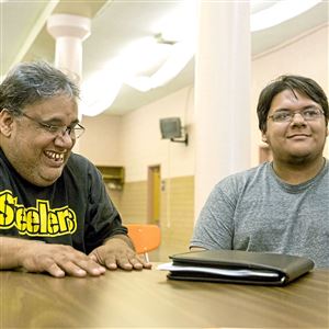 David Chavez, left, and Joel Chavez joke with Allison Rowland, a senior paralegal, and Vanessa Caruso, an attorney at law, (both not pictured) during a legal clinic held for dreamers Wednesday at St. Catherine of Siena Church in Beechview. “We knew about the plans about it before it was announced and then it turned what it became and I immediately went for it. It’s nice because I get to have a job, apply for colleges, and have a social security number. I can be like any other student at my school,” Joel Chavez, 17, says.