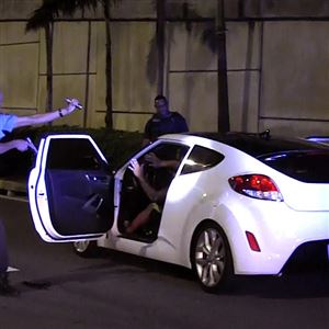 Puerto Rico Police Officer Heriberto Soto  shouts commands to the passengers and driver after a late-night high speed chase through San Juan on Oct. 18, 2017.