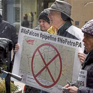 Thaddeus Popovich, of Franklin Park and co-founder of Allegheny County Clean Air Now, holds a poster with a map during a PennFuture press conference Tuesday outside of Gov. Tom Wolf's regional office in Downtown Pittsburgh where they delivered a petition with 3,000 signatures that  joined the 
