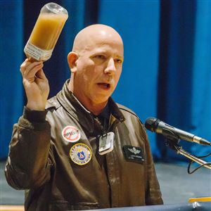 Craig Stevens, of Silver Lake Township, holds up a bottle of contaminated water collected from Dimmock, Pa. during a DEP hearing Tuesday in Monaca on the Shell Falcon Pipeline that will travel through Beaver County.