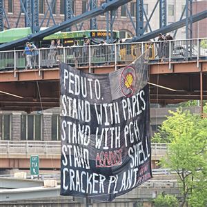 University of Pittsburgh students and alumni hang a banner on the Smithfield Street Bridge on Friday, June 1. They feel that Mayor Bill Peduto should publically oppose the Shell cracker plant, located in Beaver County.