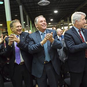 Former governors of Virginia Jim Gilmore, second from left, and Terry McAuliffe, center, applaud as current Gov. Ralph Northam announces Amazon's plans to build a new $2.5 billion headquarters in the state, Tuesday, Nov. 13, 2018, in the Crystal City area of Arlington, Va. The warehouse space where the event took place is the site of the company's first planned new office building, which will be part of over seven million square feet of related new development in a half mile of the building.