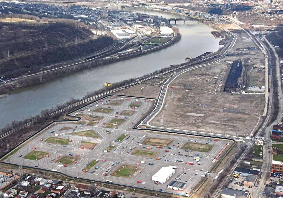 In an April 2018 photo, an aerial  view of Hazelwood Green along the Monongahela River with the city skyline in the background. In the foreground is the Uber test track. 