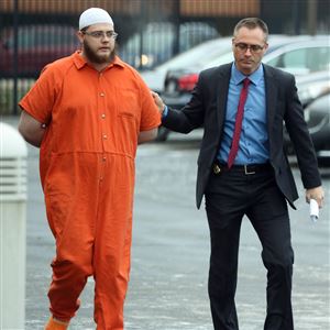 Damon M. Joseph, left, is escorted to the United States District Court for the Northern District of Ohio on December 10, 2018. 