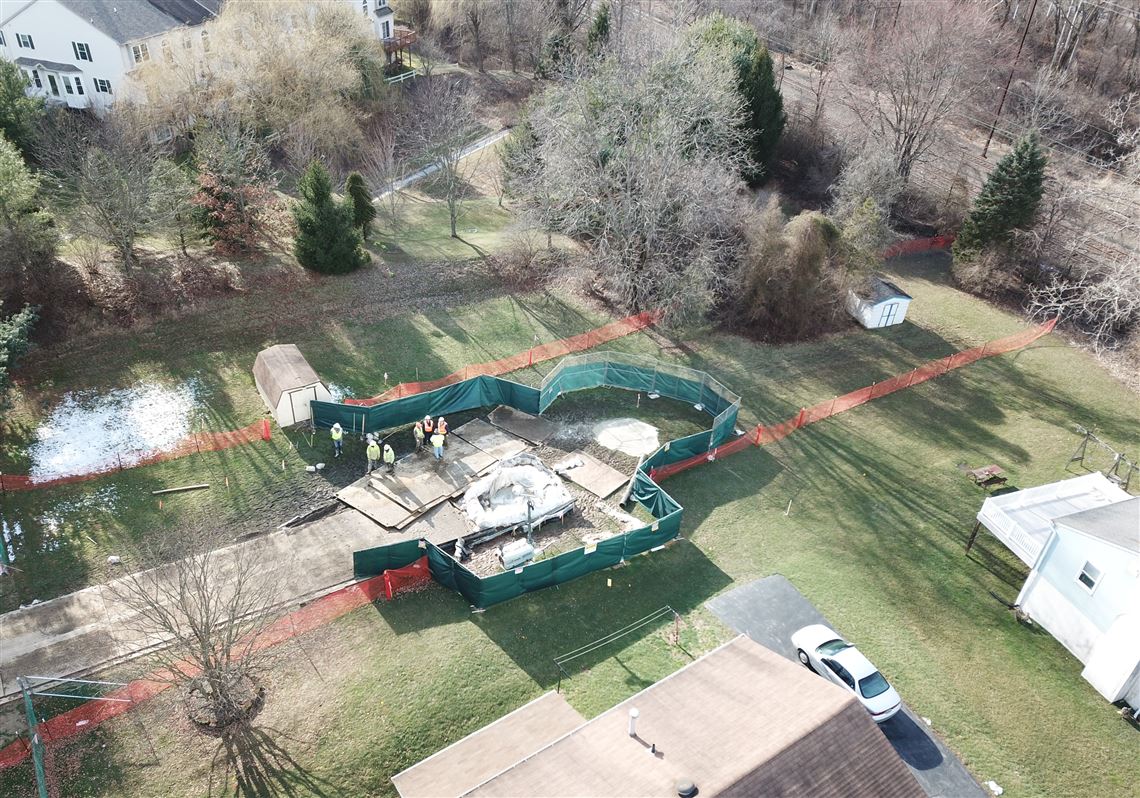 A sinkhole that developed in March 2018 is fenced off in West Whiteland, Chester County. 