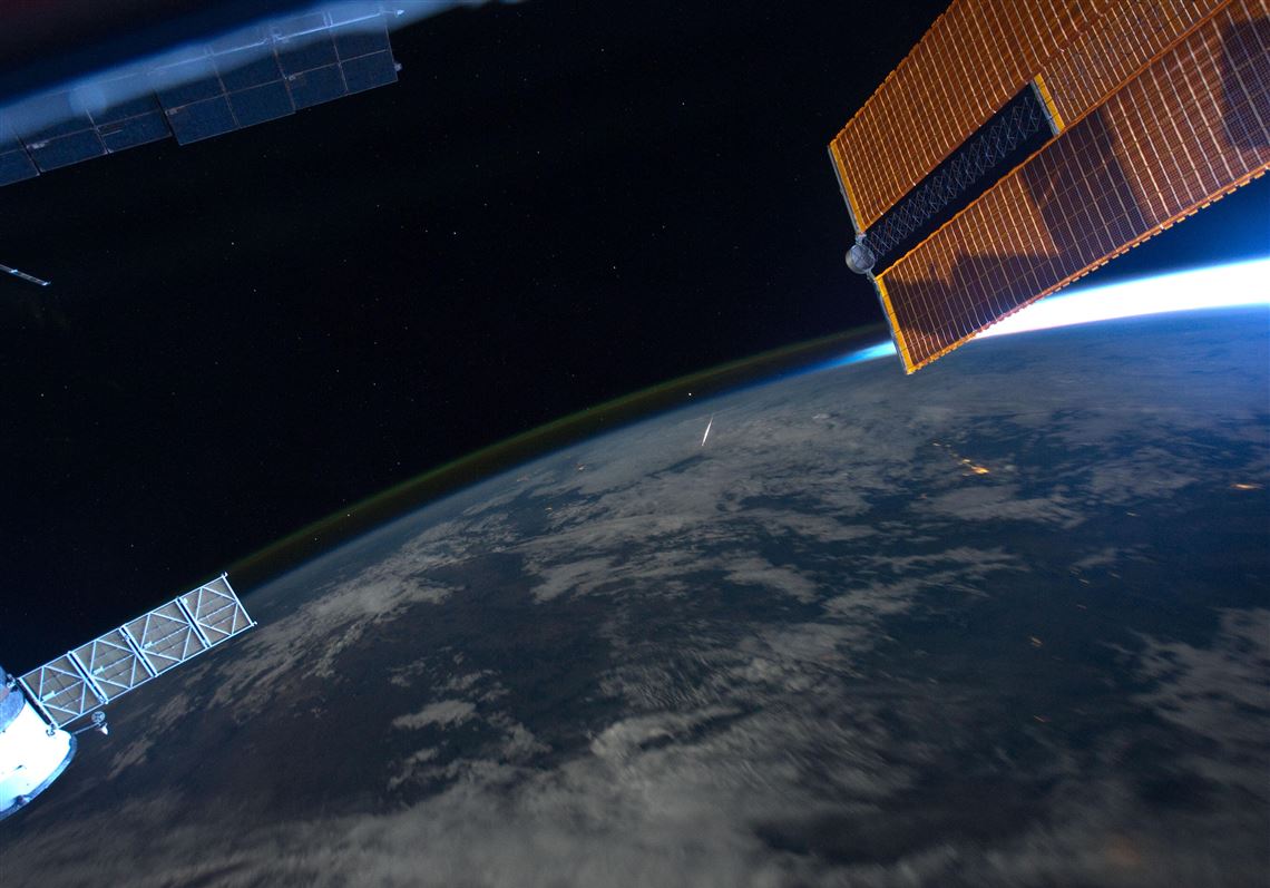 An image taken from the International Space Station in August 2011 shows the Perseid meteor shower above Earth.