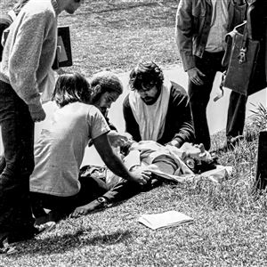 Students aid John Cleary, then 19, who was struck by Ohio National Guard gunfire at Kent State University on May 4, 1970. Mr. Cleary, now 68, of Pine, had been a relatively apolitical student at that time. He was wounded as he was watching and photographing an anti-war protest when the Guard opened fire,killing four and wounding eight other students.This photograph, which originally appeared on the cover of Life magazine on May 15, 1970, was taken by a fellow student. The two men met for the first time this month at Kent State. 